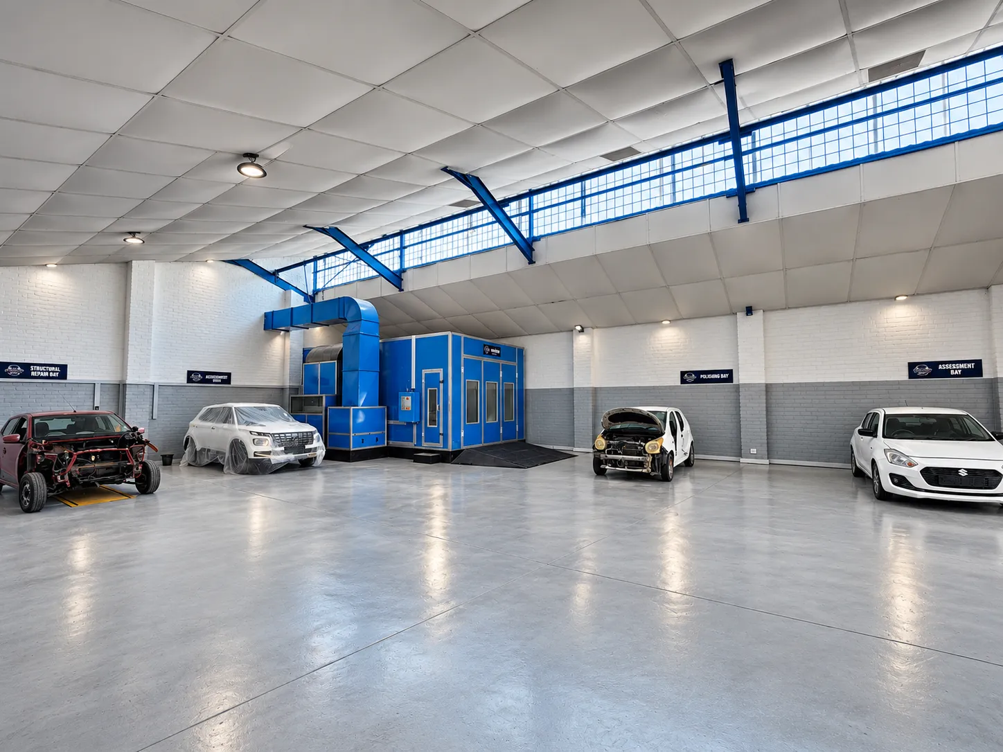 Creative Auto Worx's clean Cape Town workshop with spray booth and vehicles in repair bays